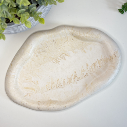 Eco-friendly stoneware dish on a white surface with text about sustainable home decor.