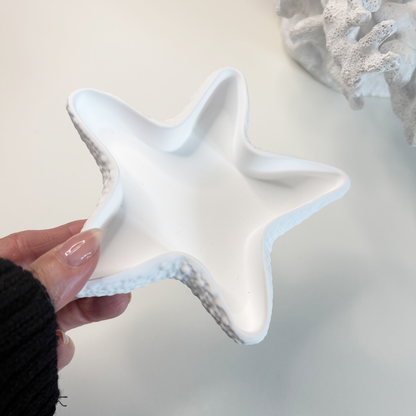 Star-shaped ceramic dish held by a hand with text about eco-friendly stoneware and sustainable home decor.