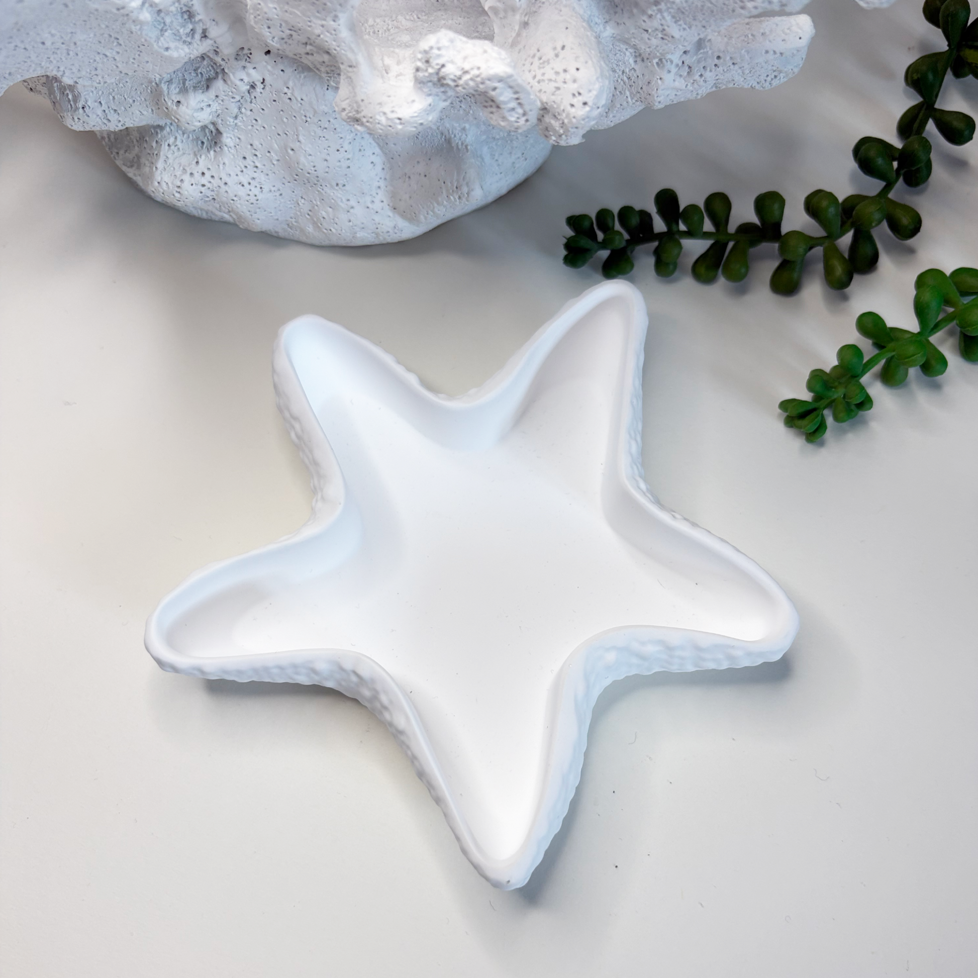 Star-shaped ceramic dish on a light surface with text about eco-friendly stoneware and sustainable home decor.