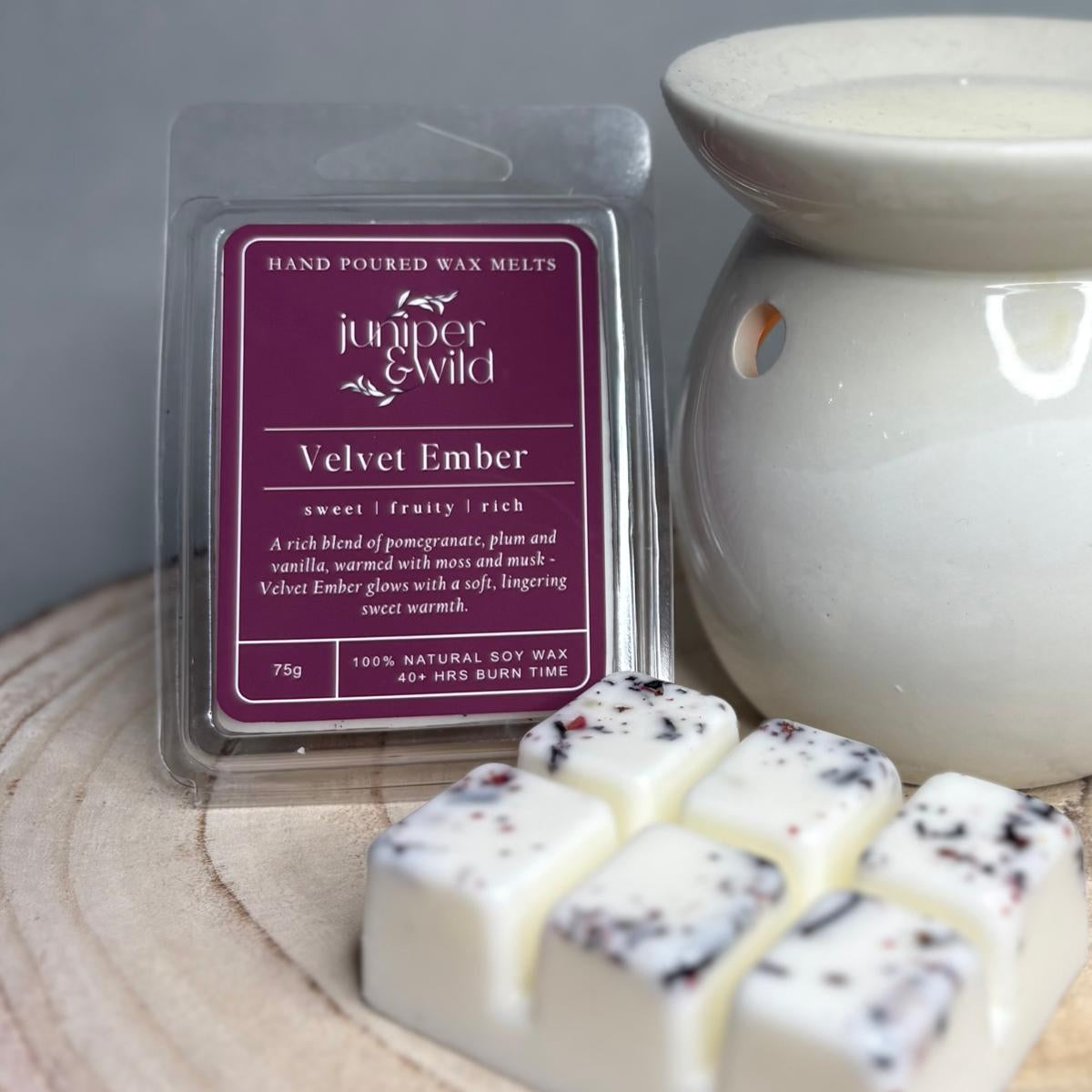Hand poured wax melts packaging with wax melts and a wax warmer on a wooden surface.