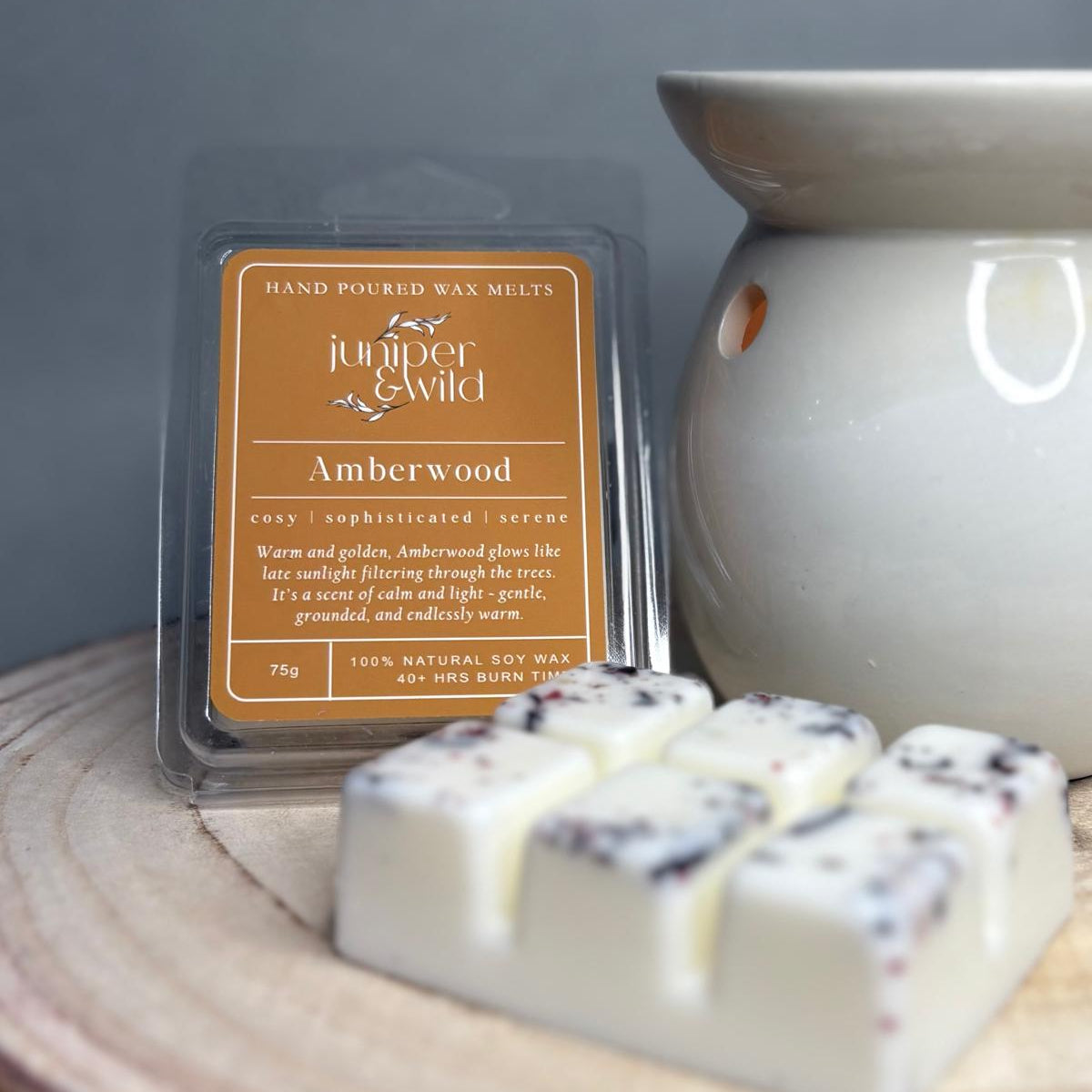 Amberwood wax melts packaging with wax melts on a wooden surface