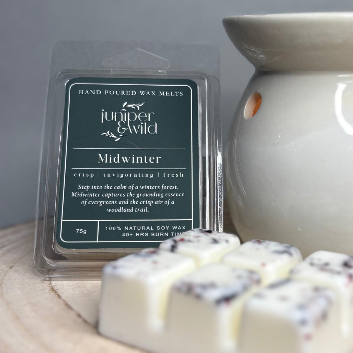 Hand poured wax melts packaging with 'juniper & Wild' branding on a wooden surface.