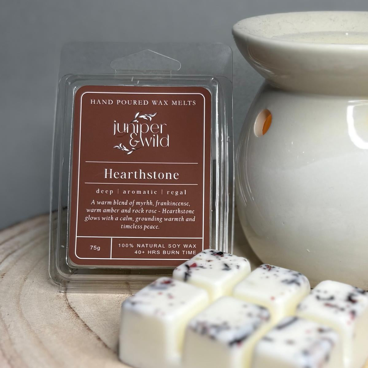 Hand poured wax melts packaging with 'juniper & wild' branding on a wooden surface.