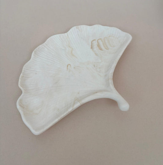 beige marble effect ginkgo leaf on a beige background